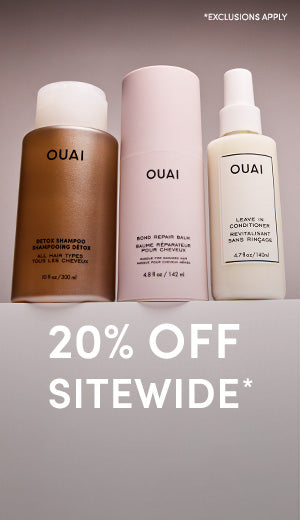 Three OUAI hair care products with a promotional text overlay on a gray background